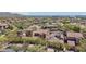 Expansive aerial view of a desert community featuring houses with terracotta tile roofs and lush landscaping at 9305 E Canyon View Rd, Scottsdale, AZ 85255