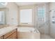 This bathroom has a soaking tub, vanity and glass enclosed shower at 9305 E Canyon View Rd, Scottsdale, AZ 85255