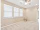 This bedroom features a ceiling fan, neutral carpet and three windows at 9305 E Canyon View Rd, Scottsdale, AZ 85255