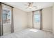This bedroom has a neutral carpet, ceiling fan and two windows at 9305 E Canyon View Rd, Scottsdale, AZ 85255