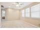 This bedroom has a neutral carpet, ceiling fan and three windows at 9305 E Canyon View Rd, Scottsdale, AZ 85255