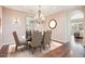 Elegant dining room features a chandelier, stylish furniture, and seamless access to the living space at 9305 E Canyon View Rd, Scottsdale, AZ 85255