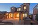 Stunning two-story home featuring a covered patio, tile roof and beautifully lit windows at 9305 E Canyon View Rd, Scottsdale, AZ 85255