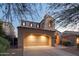 Charming home featuring a two-car garage and an inviting front porch with seating at 9305 E Canyon View Rd, Scottsdale, AZ 85255