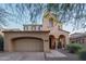 Charming home featuring a two-car garage and an inviting front porch with seating at 9305 E Canyon View Rd, Scottsdale, AZ 85255