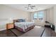 The main bedroom features wood floors, ceiling fan and window with curtains at 9305 E Canyon View Rd, Scottsdale, AZ 85255