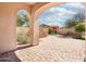 Covered patio with brick pavers overlooks a landscaped yard with a built in grill station at 9305 E Canyon View Rd, Scottsdale, AZ 85255