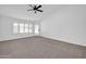 Bright bedroom with neutral carpeting and sliding doors at 9544 W Sierra Pinta Dr, Peoria, AZ 85382