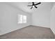 Spacious bedroom featuring carpet, ceiling fan, and window shutters at 9544 W Sierra Pinta Dr, Peoria, AZ 85382