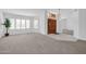 Bright entryway with wood door and neutral carpeting at 9544 W Sierra Pinta Dr, Peoria, AZ 85382