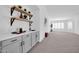 Modern wet bar with gray cabinets and white countertops at 9544 W Sierra Pinta Dr, Peoria, AZ 85382