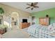 Serene bedroom with green accent wall and ensuite bathroom access at 9606 S 23Rd Dr, Phoenix, AZ 85041