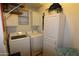 Laundry room with washer, dryer, and storage cabinets at 11500 E Cochise Dr # 2070, Scottsdale, AZ 85259