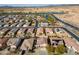 Aerial view shows a well-planned community with desert landscaping, and neighborhood lakes and green spaces at 126 E Key West Dr, Casa Grande, AZ 85122