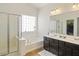 Bright bathroom with a shower, and tub underneath a large window, with a double sink vanity at 126 E Key West Dr, Casa Grande, AZ 85122