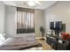 Simple bedroom featuring a bed, a window, and a dresser at 126 E Key West Dr, Casa Grande, AZ 85122