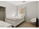 Light-filled bedroom with a bed, a side table and chair, and a view to a walk-in closet space at 126 E Key West Dr, Casa Grande, AZ 85122