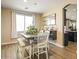 Charming dining room featuring a gray table with benches, lots of light, with seamless flow to kitchen at 126 E Key West Dr, Casa Grande, AZ 85122