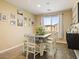 Inviting dining room with a gray wood table, stylish decor, bright natural light, and wood-look floors at 126 E Key West Dr, Casa Grande, AZ 85122