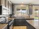 Lovely kitchen with dark cabinets, granite countertops, stainless steel appliances, tile floors and sunny window at 126 E Key West Dr, Casa Grande, AZ 85122