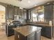 Well-appointed kitchen with dark cabinets, granite countertops, stainless steel appliances, and center island at 126 E Key West Dr, Casa Grande, AZ 85122