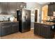 Well-lit kitchen featuring dark cabinets, stainless steel appliances, and granite countertops at 126 E Key West Dr, Casa Grande, AZ 85122