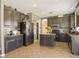 Large kitchen featuring dark cabinets, stainless steel appliances, tile floors and center island with seating at 126 E Key West Dr, Casa Grande, AZ 85122
