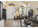 Bright living room with high ceilings, large windows, neutral walls and two cozy sofas at 126 E Key West Dr, Casa Grande, AZ 85122
