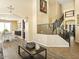 Open-concept living room featuring stairs to the second floor and a dining table set at 126 E Key West Dr, Casa Grande, AZ 85122
