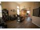 Bright living room featuring high ceilings, a large sofa, and an open layout flowing into the dining area at 126 E Key West Dr, Casa Grande, AZ 85122