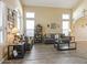 Bright, open living room featuring two sofas, arched windows, high ceilings, and wood-look flooring at 126 E Key West Dr, Casa Grande, AZ 85122