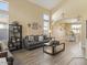 Open-concept living room with tall ceilings, large windows, gray sofa and seamless flow into the dining area at 126 E Key West Dr, Casa Grande, AZ 85122