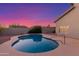 Inviting kidney-shaped pool in the backyard at sunset at 12815 E Becker Ln, Scottsdale, AZ 85259