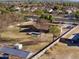 Aerial view showing a house with a pool, expansive yard, and detached structures at 14040 E Ocotillo Rd, Chandler, AZ 85249