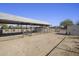 Long covered stalls and a storage shed in a fenced area at 14040 E Ocotillo Rd, Chandler, AZ 85249