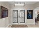 Bright and airy entryway with double doors and modern light fixture at 14301 W Circle Ridge Dr, Sun City West, AZ 85375