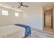 Bright bedroom with ceiling fan and sliding door to patio at 14825 S Charco Rd, Arizona City, AZ 85123