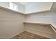 Spacious walk-in closet with wood shelving at 14825 S Charco Rd, Arizona City, AZ 85123
