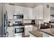 Bright kitchen features stainless steel appliances and white cabinets at 15021 S 47Th St, Phoenix, AZ 85044