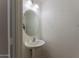Clean and simple bathroom with pedestal sink and oval mirror at 15877 W Diamond St, Goodyear, AZ 85338