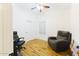 Bedroom with wood floors, ceiling fan, and recliner at 15877 W Diamond St, Goodyear, AZ 85338