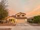 Two-story house with tan exterior, tile roof, and a two-car garage at 15877 W Diamond St, Goodyear, AZ 85338