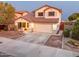 Two-story house with tan exterior, tile roof, and a two-car garage at 15877 W Diamond St, Goodyear, AZ 85338