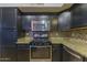 Modern kitchen with stainless steel appliances and granite countertops at 15877 W Diamond St, Goodyear, AZ 85338