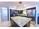 Spacious kitchen with granite countertops, stainless steel appliances, and an island at 15877 W Diamond St, Goodyear, AZ 85338