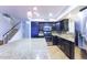 Open kitchen with granite island and stainless steel appliances at 15877 W Diamond St, Goodyear, AZ 85338