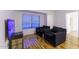 Living room with wood flooring and two comfy armchairs at 15877 W Diamond St, Goodyear, AZ 85338