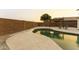Relaxing kidney-shaped pool with pergola and chairs at 15877 W Diamond St, Goodyear, AZ 85338