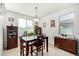 Bright dining room featuring a wood table and matching hutch at 1673 E Jardin Pl, Casa Grande, AZ 85122