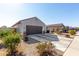 House exterior showcasing a two-car garage and drought-tolerant landscaping at 1673 E Jardin Pl, Casa Grande, AZ 85122